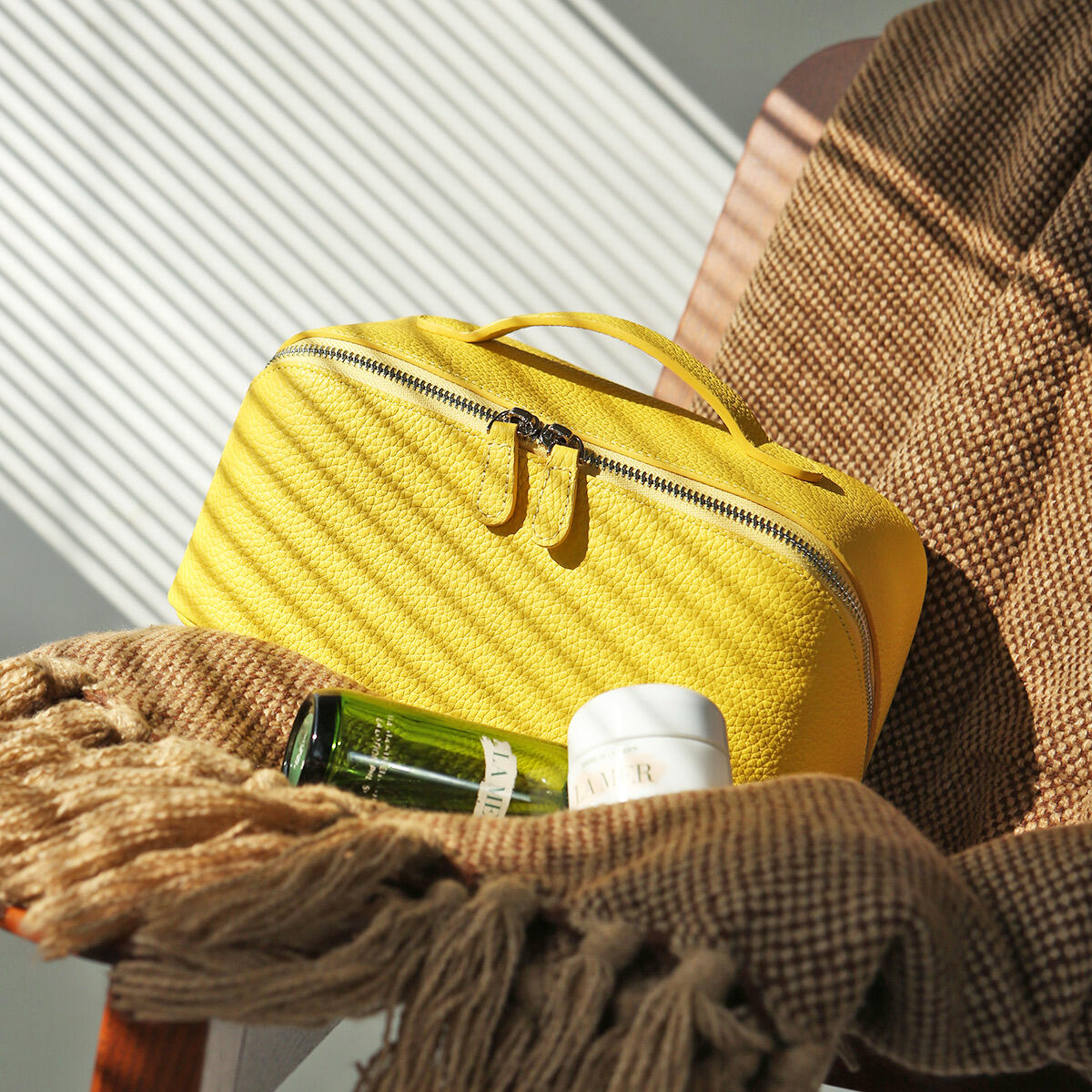 Noma Vanity Case in yellow grained leather with structured silhouette and top handle