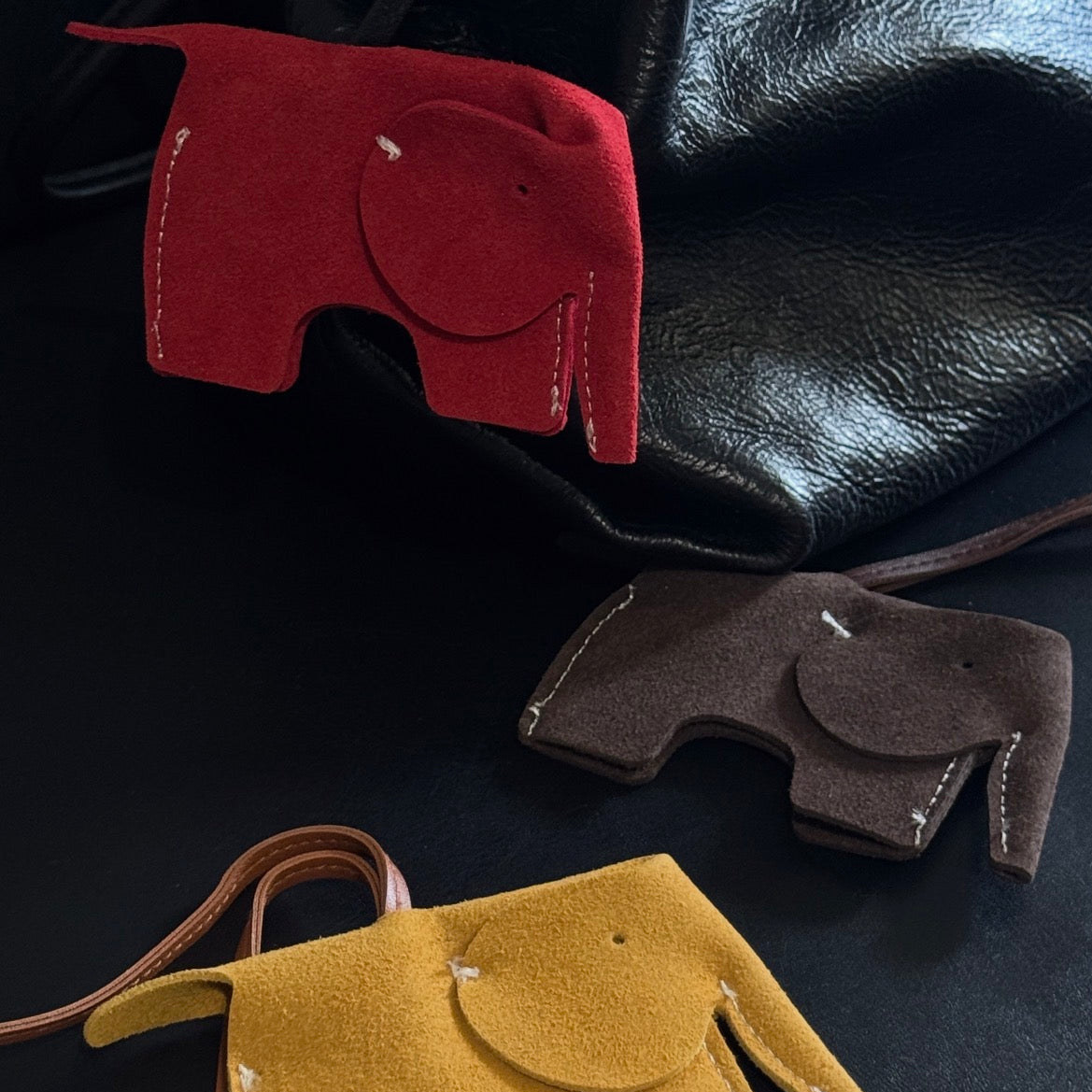 Mustard Tavi genuine leather elephant bag charm with visible stitching and metal ring