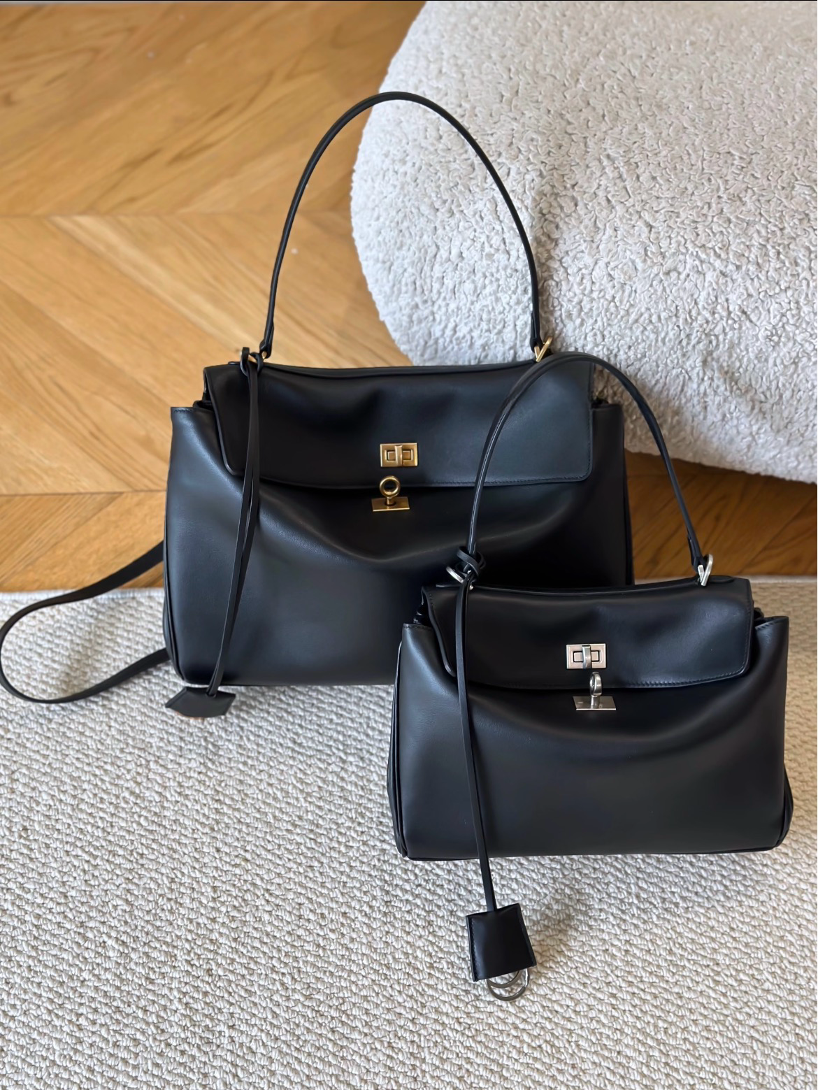 Black Eloria genuine top-grain leather handbag with gold turn-lock closure