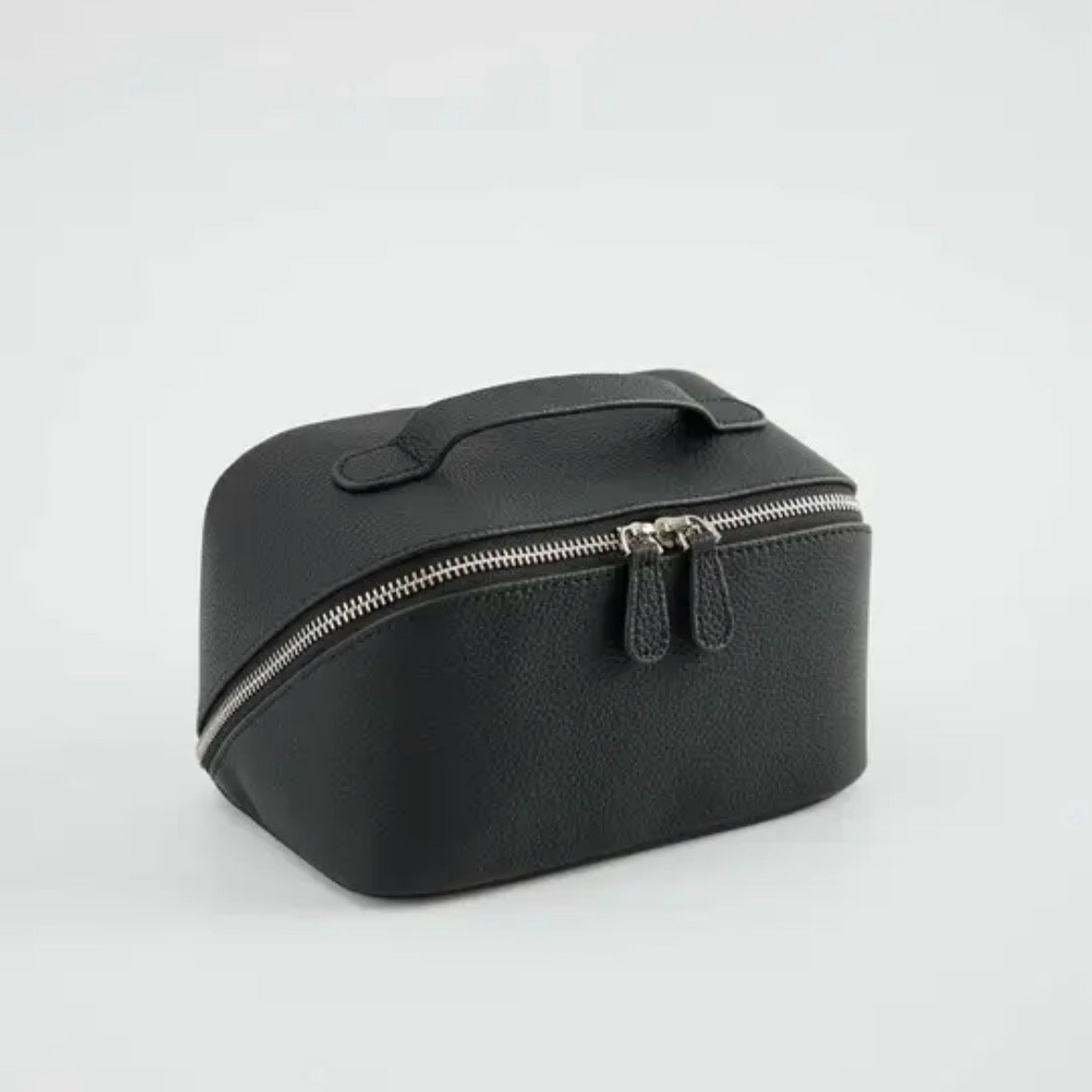 Noma Vanity Case in black grained leather with structured silhouette and top handle